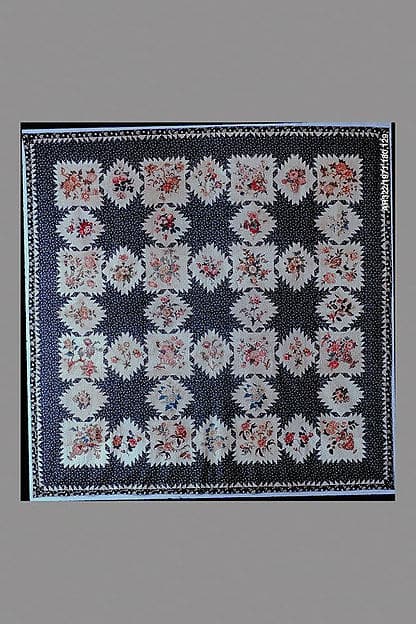 Feathered Star pattern quilt with chintz appliques