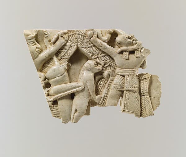 Furniture plaque carved in relief with winged figures, locust, and monkey