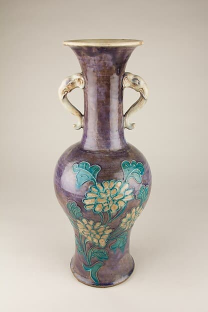 Vase with elephant head handles and floral decoration