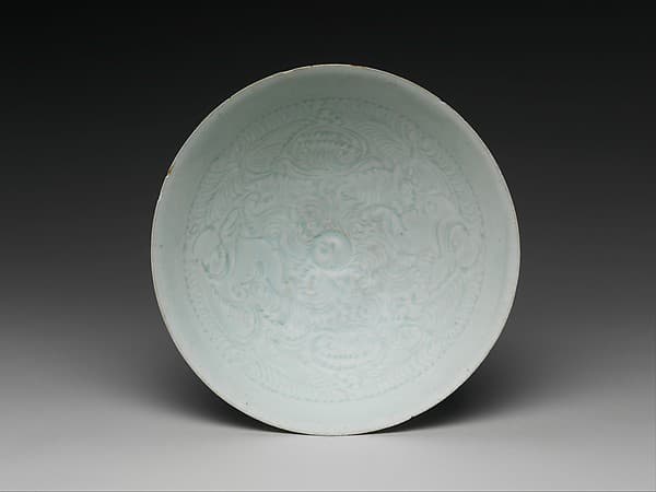 Bowl with two boys and foliage