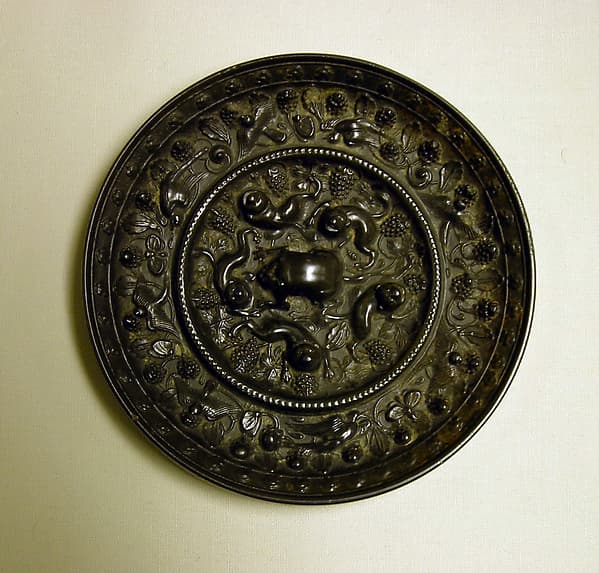Mirror with fantastic animals amid grape vines