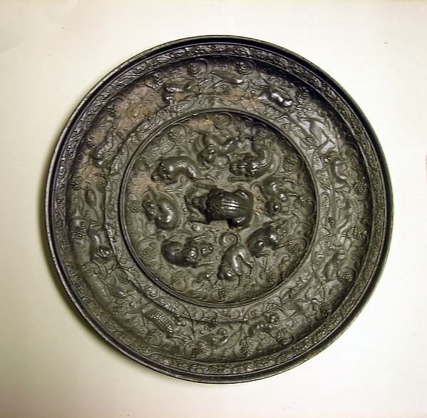 Mirror with fantastic animals amid grape vines