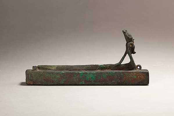 Atum as a human-headed cobra surmounting a box for an animal mummy