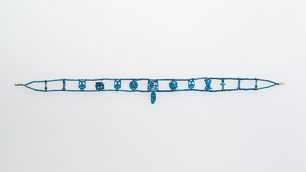 Necklace restrung with amulets and a faience cartouche bead of Tutankhamun