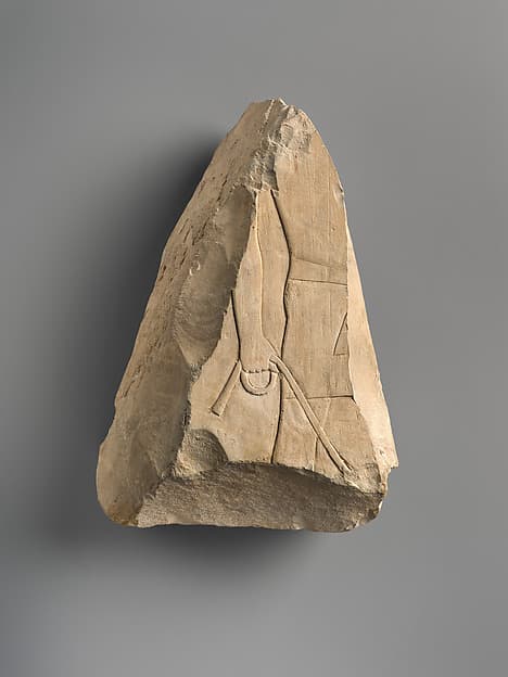 Raised relief fragment of a man bringing a leashed animal
