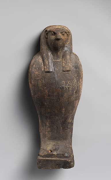 Falcon-headed coffin and grain mummy with Osiris mask