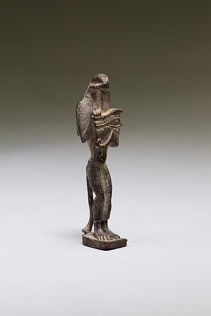 Nehebkau (snake deity) holding a wedjat eye