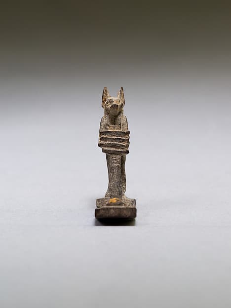 Anubis (?) supporting a large djed pillar