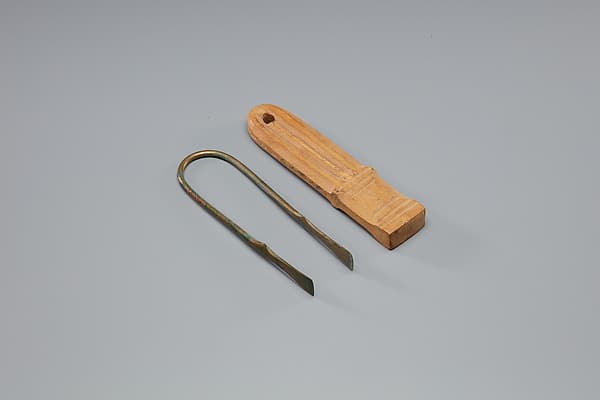 Tweezers Mounted on a Wood Block