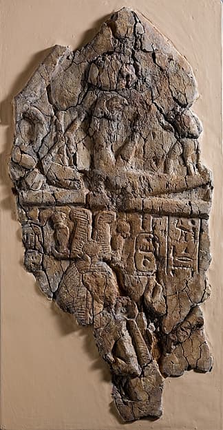 Fragment of Stela depicting a figure labeled 'excellent spirit of Re' facing Ramesses I and Ahmose-Nefertari beneath the barque of Re