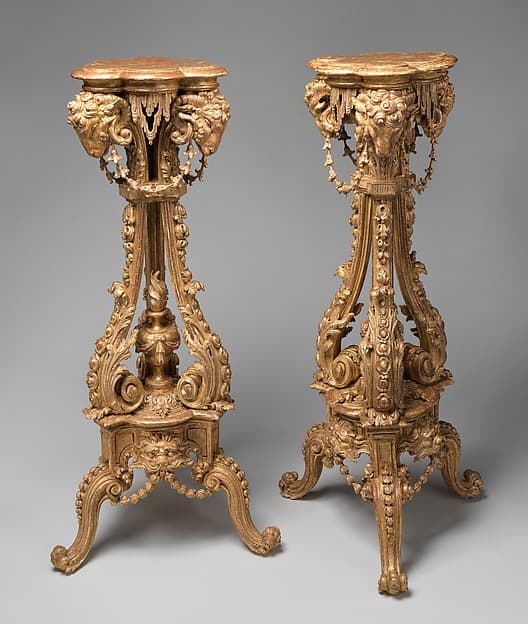 Pair of tripod candlestands or torchères, by Thomas Chippendale