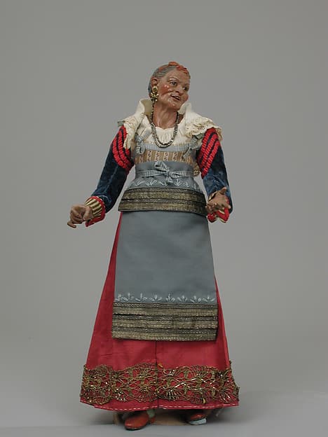 Old woman carrying a wire basket