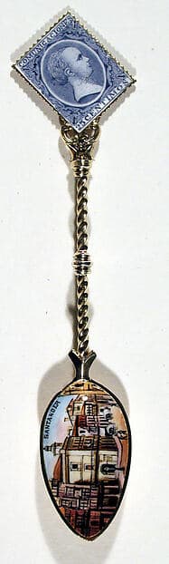 Souvenir spoon with view of a street scene and finial in form of a postage stamp
