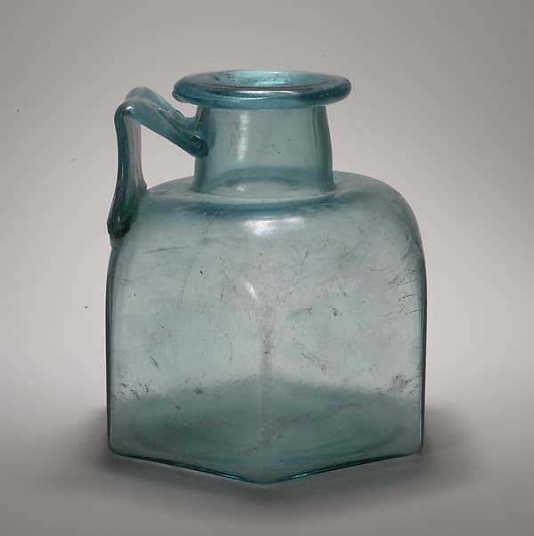 Glass one-handled hexagonal bottle