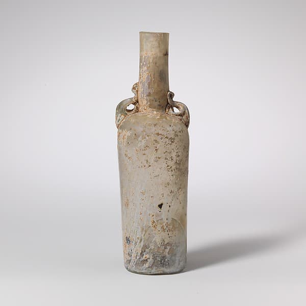 Glass bottle with dolphin handles