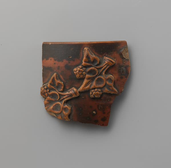 Terracotta applique fragment of ivy leaves and berries