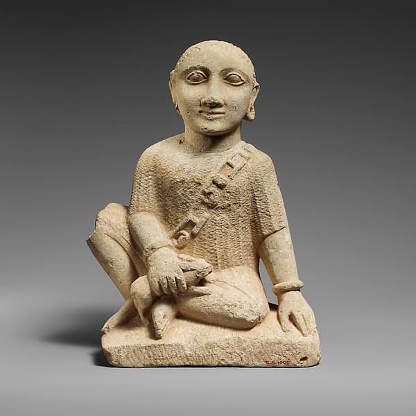 Limestone statuette of a temple boy