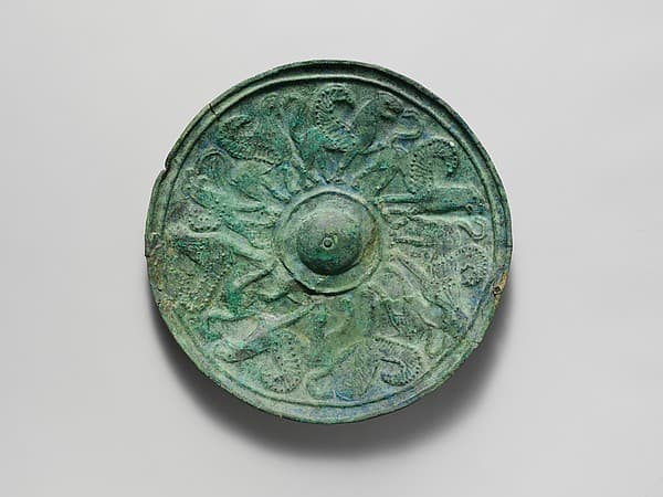 Bronze shield boss with griffin and sphinx frieze