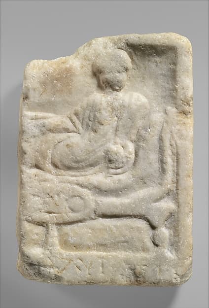 Fragment of a marble votive relief dedicated to a hero