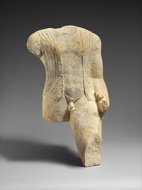 Limestone figure of a draped man