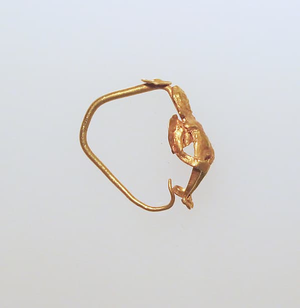 Gold earring with winged figure