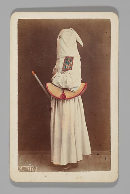 [Studio Portrait: Person Wearing White Robe and Face Covering Hood, Naples], by Giorgio Conrad