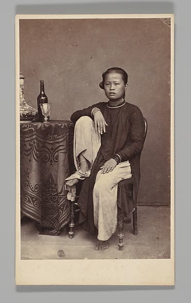 [Studio Portrait: Woman Seated Beside a Table, Singapore], by G. R. Lambert & Co.