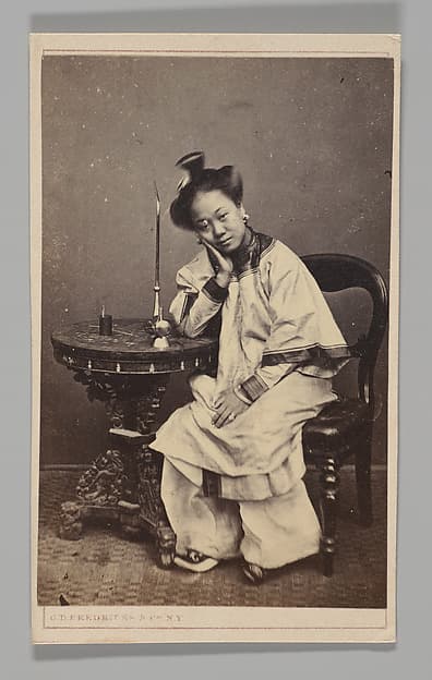 [Studio Portrait: Woman Seated Beside a Table Leaning on Elbow], by C.D. Fredricks & Co.