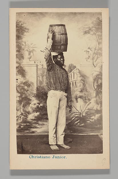 [Studio Portrait: Male Street Vendor with Barrel on Head, Brazil], by Christiano Junior