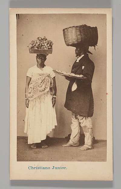 [Studio Portrait: Female and Male Street Vendors with Baskets on Head, Brazil], by Christiano Junior