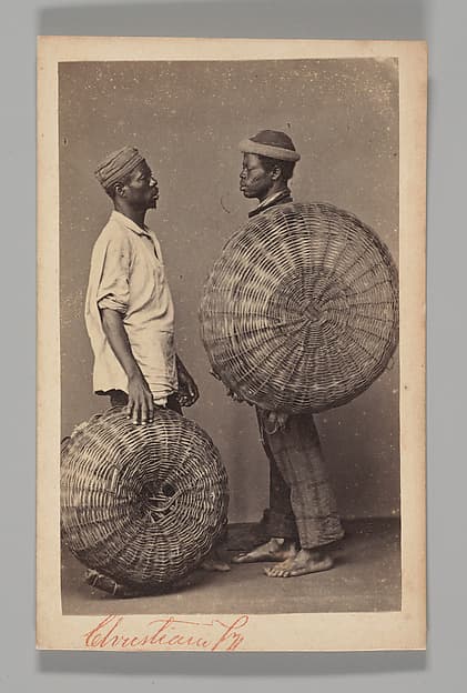 [Studio Portrait: Two Male Street Vendors in Profile with Baskets, Brazil], by Christiano Junior