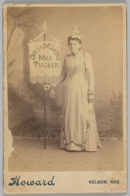 [Merchants' Carnival Portrait: Dress Making Mrs. Tucker, Nelson, Nebraska], by Howard