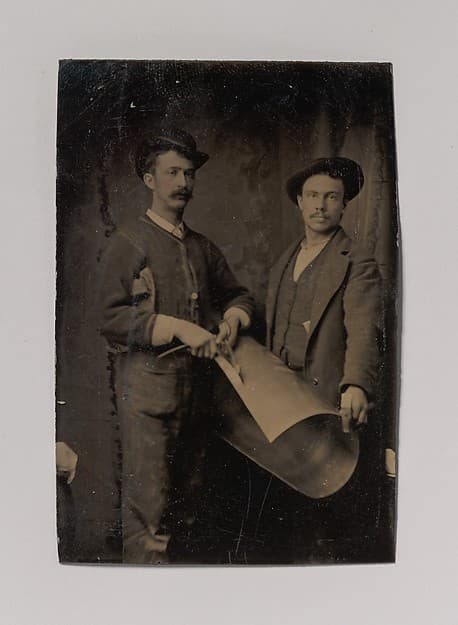 [Two Tinsmiths Cutting a Curled Sheet of Metal], by Unknown