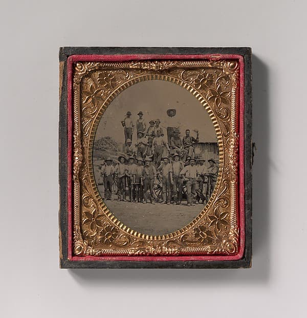 [Crew of Twenty-one Workmen Posing With Tools Outdoors], by Unknown