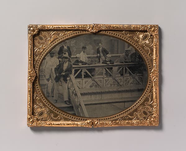 [Group of Men and Boys Standing Along the Railing of the Fulton Street Bridge], by Unknown