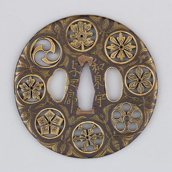 Sword guard (Tsuba) Depicting Crests and Arabesques (家紋散唐草文鐔), by Koike Izumi no Kami Naomasa