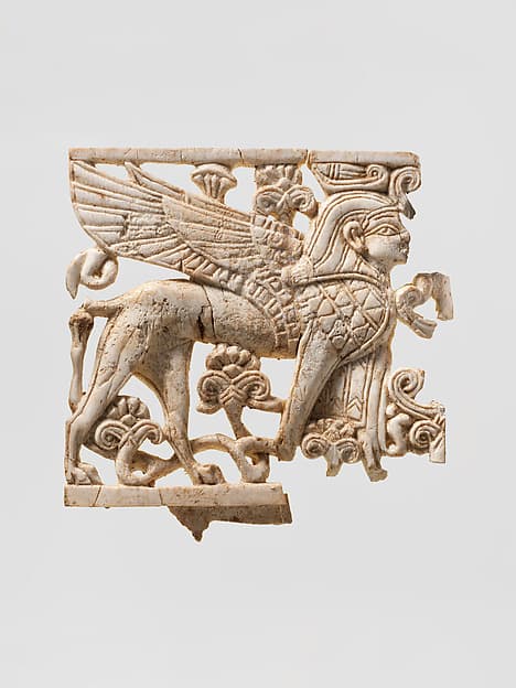 Openwork plaque with a sphinx striding through a floral landscape