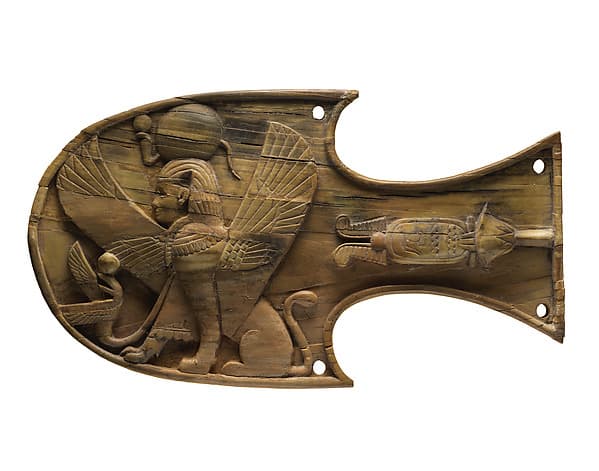 Horse blinker carved in relief with a seated sphinx