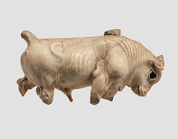 Furniture or cosmetic box plaque carved in the round with striding bull