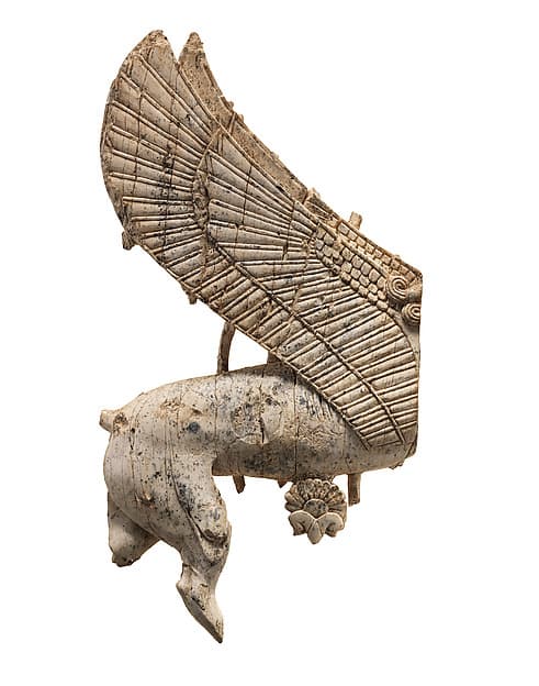 Openwork furniture plaque with sphinx striding through a floral landscape