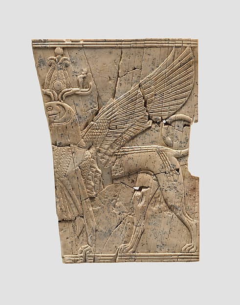 Furniture plaque carved in relief with a winged, falcon-headed sphinx