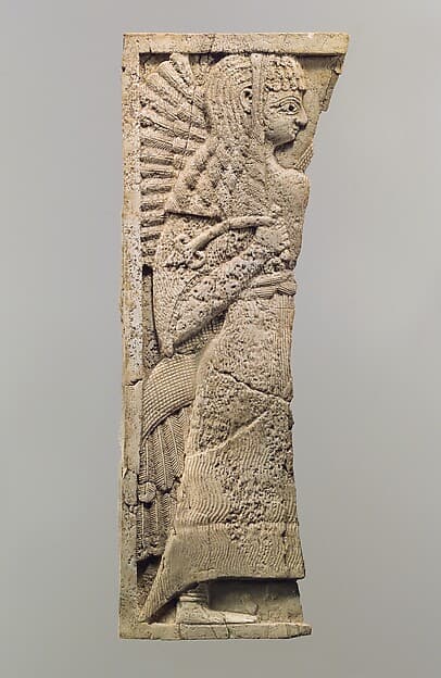 Furniture plaque carved in relief with standing woman