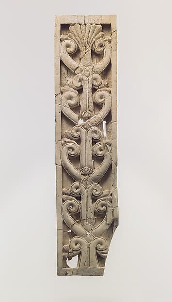 Furniture plaque carved in relief with volutes and a palmette