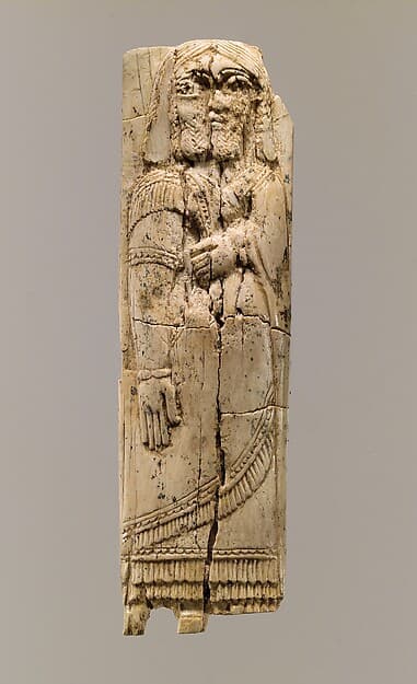Furniture plaque with figure in relief