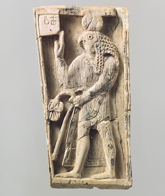 Furniture plaque carved in relief with a falcon-headed figure