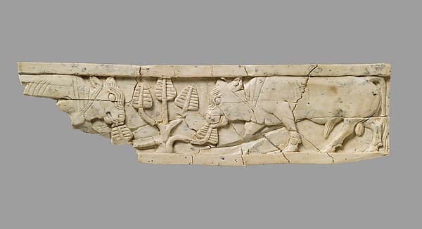 Furniture plaque carved in relief with bulls and tree