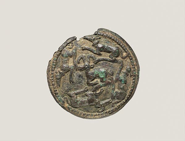Disc with running dogs surrounding a mountain goat