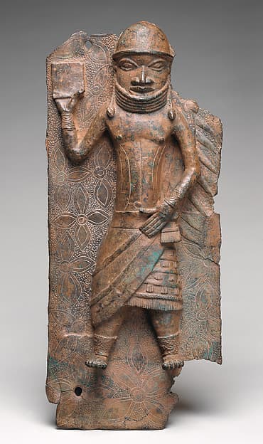 Plaque with Court Official Holding a Protective Amulet, by Ìgùn Ẹ́rọ̀nwwọ̀n (brass-casting guild) artists