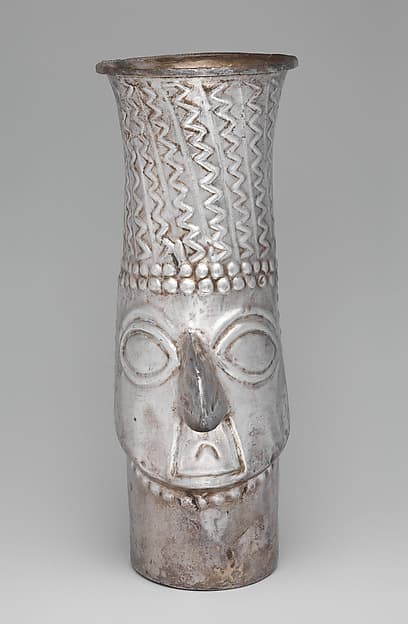Beaker with face, by Inca artist(s)