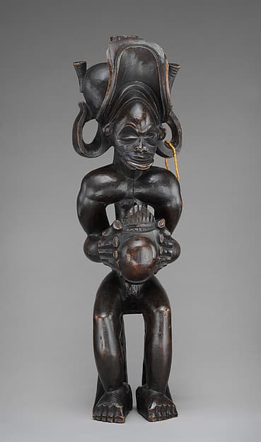 Mwanangana (lord of the land) playing a sanza, by Chokwe artist